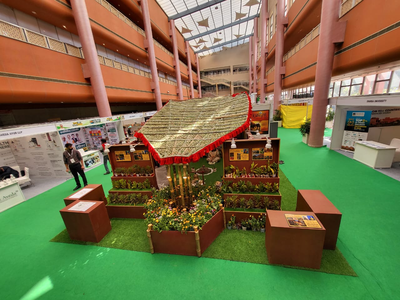 Alternate front angle showing woven roof, display panels, and planters